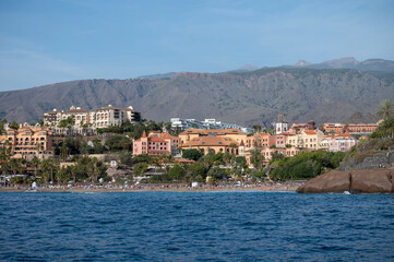 Fototapeta premium View on resorts and beaches of South coast of Tenerife island during sail boat trip along coastline, Canary islands, Spain