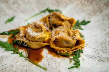 Italian food, veal cheek ravioli with balsamic and grated parmesan cheese - obrazy, fototapety, plakaty