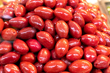 Red olives close up on market, food background