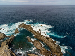 Aerial view on Charco del Viento natural pool in black lava rocks on Tenerife, Canary islands, Spain