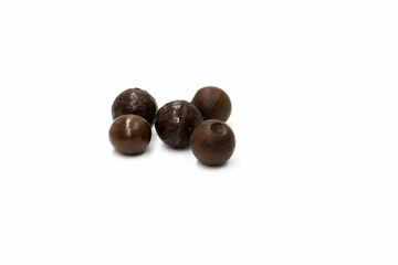 Five different round chocolate candies on a white background
