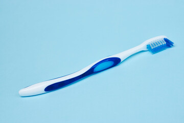 Blue toothbrush on a blue background with copy space