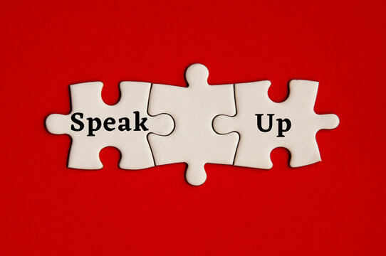 Text on missing jigsaw puzzle - Speak up. With red background.