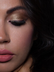 Half the face of a young sexy woman with pink lipstick on her lips and black eyeliner. Classic makeup and straight long hair. Evening make-up, cosmetology, spa, cosmetics, rejuvenation
