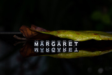 Mote alphabet blocks arranged into the name 