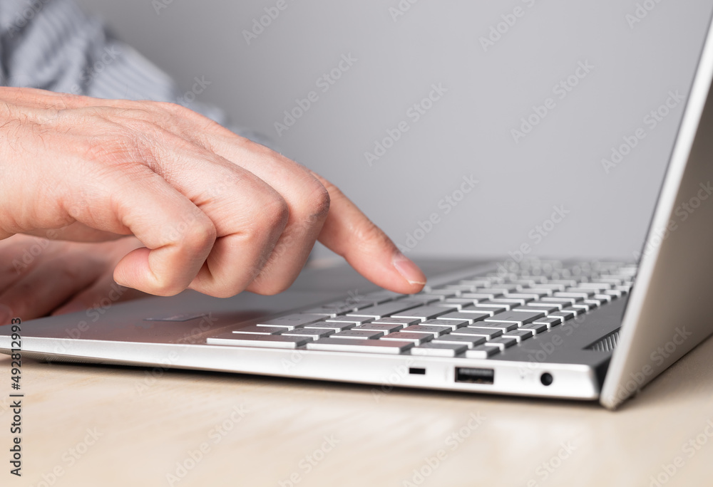 Aufkleber man hand closeup pressing enter key. man sitting at table and working on laptop. high quality photo