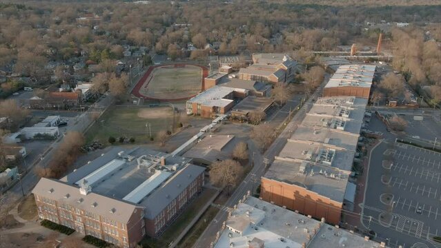 Establishing shot of Durham neighborhood and soccer field in background in North Carolina, USA. Aerial forward