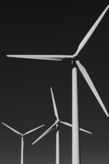 close up of white wind turbines on black background