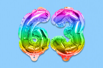 Rainbow foil balloon number, digit sixty three on a blue background. Birthday greeting card with inscription 63. Top view. Numerical digit. Celebration event, template.