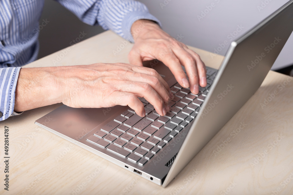 Poster man hands closeup typing on laptop keyboard. data search, distant work and education, online shoppin