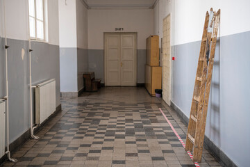 Empty School hallway. School closed due coronavirus, covid19 pandemic lockdown. On-line teaching. Old vintage floors and walls.