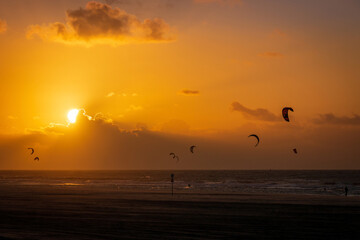 Kitesurfer at Kijkduin North Sea beach at sunset
