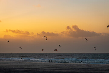 Kitesurfer at Kijkduin North Sea beach at sunset