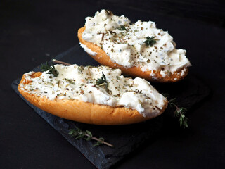 Sandwiches with curd cheese and herbs. Cream cheese with thyme on white toasted bread. Close up