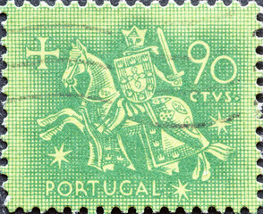 Portugal - circa 1953: a postage stamp from Portugal, showing a horse with rider in armor Knight on horseback from the seal of King Dinis . 90 CTVS green
