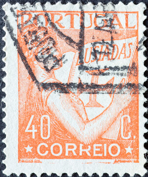 Portugal - circa 1931: a postage stamp from Portugal, showing a woman with historical book Lusiadas in which is depicted a cross.