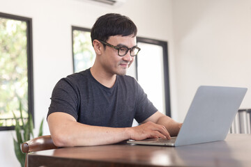 asian man work using computer hand typing laptop keyboard contact us.student study learning education online.adult professional people chatting search at office.concept for technology device business