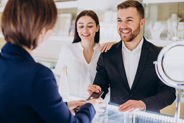 Couple at jewelry shop paying with card