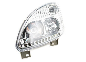 Stylish xenon headlight for truck or pickup - optical equipment with a lamp inside on a white isolated background. Spare part for auto repair in a car workshop.