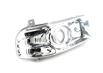 Stylish xenon headlight for truck or pickup - optical equipment with a lamp inside on a white isolated background. Spare part for auto repair in a car workshop.