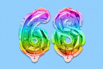 Rainbow foil balloon number, digit sixty eight on a blue background. Birthday greeting card with inscription 68. Top view. Numerical digit. Celebration event, template.