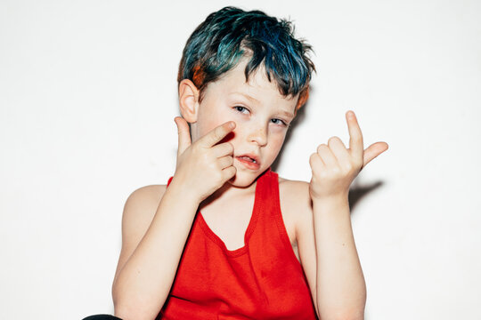 Naughty boy showing sign to camera