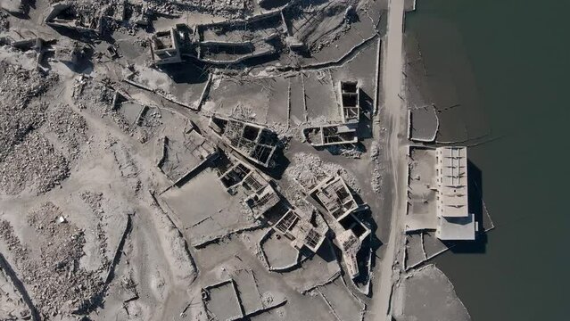 Aerial top-down descending over ruins of Aceredo submerged village in Galicia on dry season, Spain