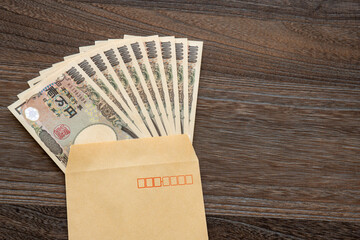 Japanese 100,000 yen banknote in an envelope