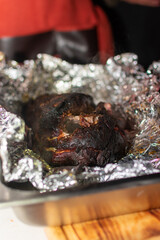 Fototapeta na wymiar pulled pork cerdo deshebrado bbq de cerdocarne de cerdo envuelta en papel aluminio cocinada al carbón en el asador y deshebrada con pinzas 
