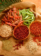 Variety of grains and beans on rustic background