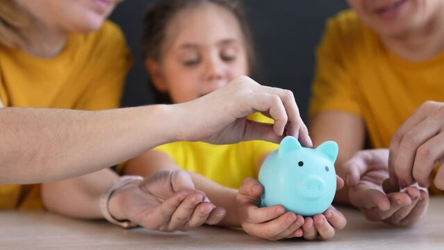 piggy bank. happy family lifestyle a save money. business investment finance piggy bank concept. happy family hands holding piggy bank. kid and parents put coins in investment money box