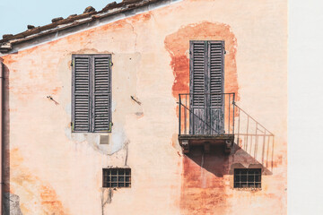 Fototapeta na wymiar Exterior of ancient house abandoned, balcony and windows