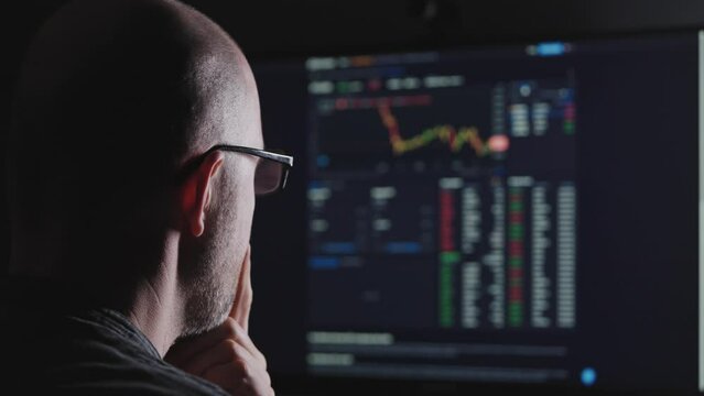 Online work on the stock exchange. A man uses the stock exchange for investments.