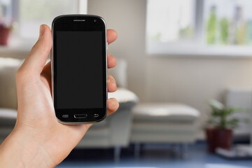 Internet of things. Focus on modern smartphone with blank screen for smart home control system