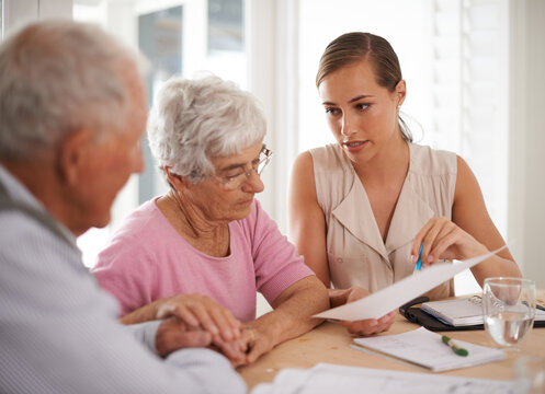 Shell make sure they get great coverage. A young businesswoman explains information to an elderly couple.