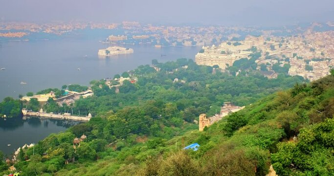 Aerial view of Lake Pichola with Lake Palace (Jag Niwas) and City Palace and cable car rope way. Udaipur, Rajasthan, India
