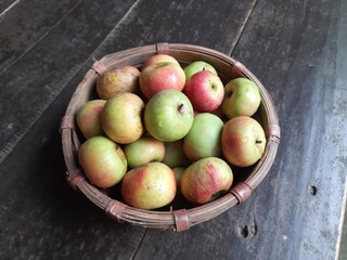 Apple fruits in Bamboo Basket. It is a most popular fruits in all over world. It's found many vitamins, Which helps us fight diseases. It is found everywhere in the world.