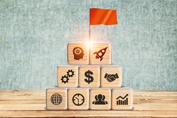 Business startup concept with growth success process for Leadership. Red flag on the top of wooden cube blocks