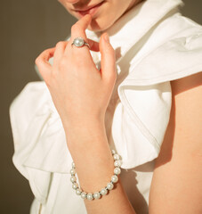Portrait of a young Ukrainian girl in a white dressYoung beautiful Ukrainian woman sitting on the floor on a round rug looks to the mirror hair gathered in a stylish hairstyle has brown eyes beautiful