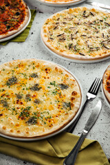 Assorted group of freshly baked pizzas on the table