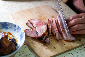 A chef is making fillings for char siu bao, dicing char siu pork