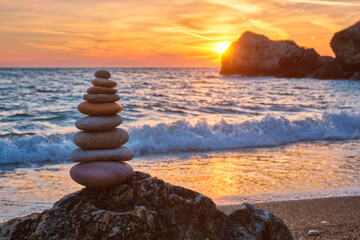Concept of balance and harmony. Cairn stack of stones pebbles cairn on the beach coast of the sea...