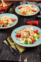 Different types of caesar salad with chicken salmon and shrimp