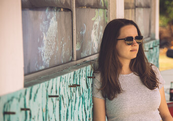 Young woman relaxes while leaning against a wall - photo shoot on the Florida Keys - travel photography