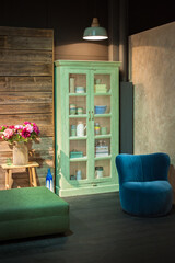 interior of a cozy rural modern house in the mountains with green-menthol cabinet for dishes
