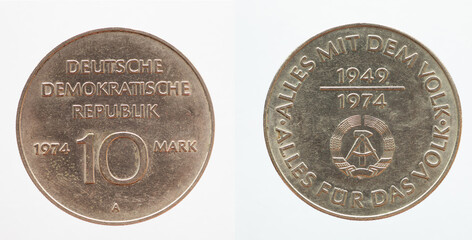 Germany East GDR - circa 1974: a 10 Mark coin of the GDR with the Hammer and Zirkle coat of arms of the GDR. Text: Everything with the people. Everything for the people