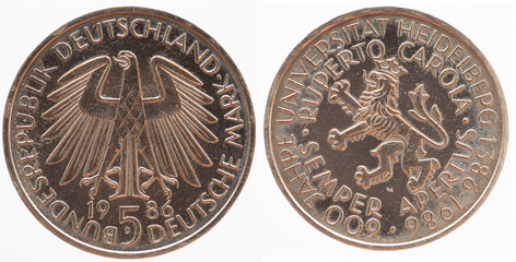 Germany - circa 1986: a 5 DM coin of Germany with the federal eagle and the coat of arms of the University of Heidelberg for the 600 year celebration