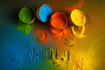 Happy Holi background. Organic colors powder in bowl for Holi festival.
