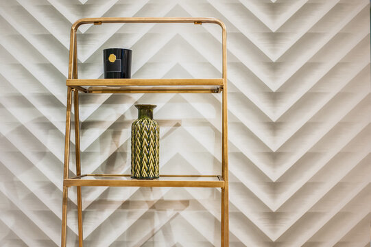 light wooden wall stand rack against geometric zigzag wallpaper