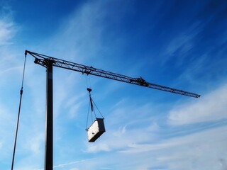 moving crane with hooked construction material